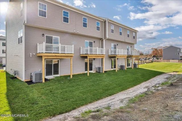 a view of a house with a yard and sitting area
