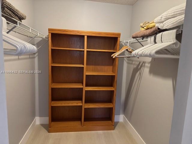 16300 Golf Club Road, Unit 208 Weston, FL 33326 - Photo 17 of 24 a view of walk in closet with empty racks