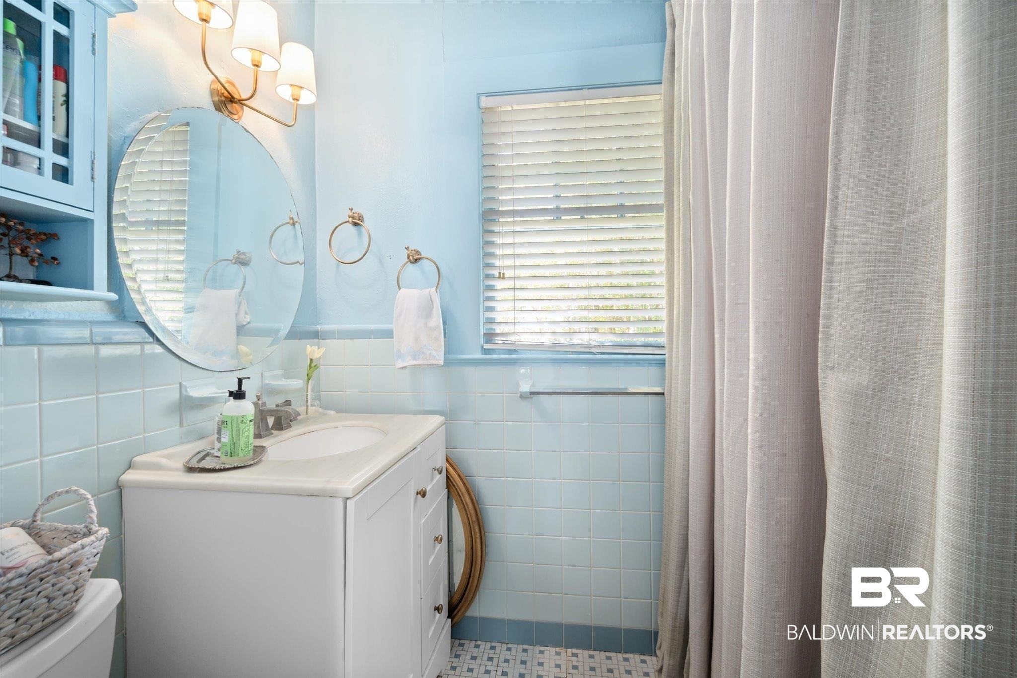 115 Bienville Avenue Mobile, AL 36606 - Photo 11 of 19 Bathroom featuring vanity, tile walls, toilet, and curtained shower