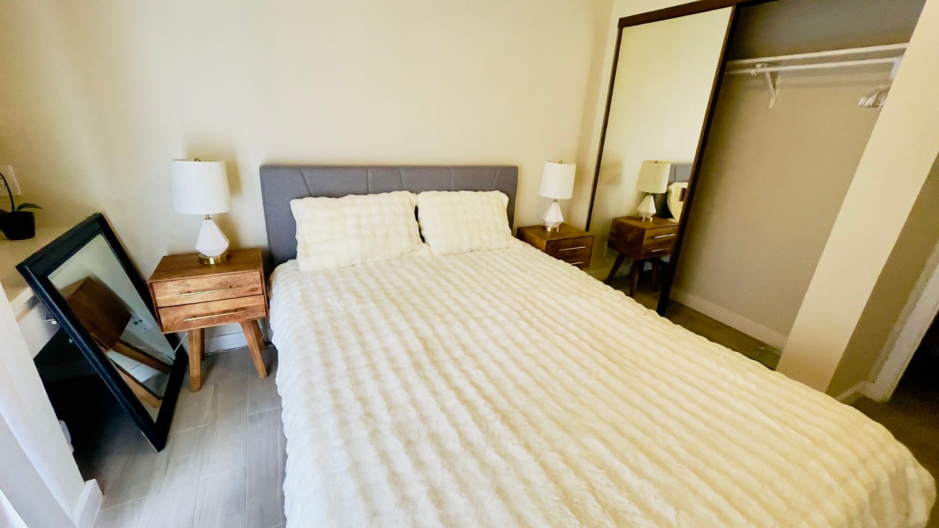 2902 Cole Street, Unit 311 Austin, TX 78705 - Photo 12 of 16 Bedroom featuring a closet and wood finished floors