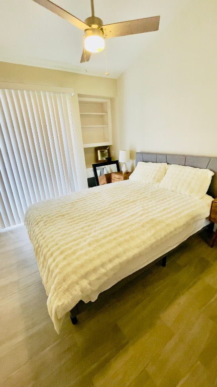 2902 Cole Street, Unit 311 Austin, TX 78705 - Photo 14 of 16 Bedroom featuring wood finished floors and ceiling fan