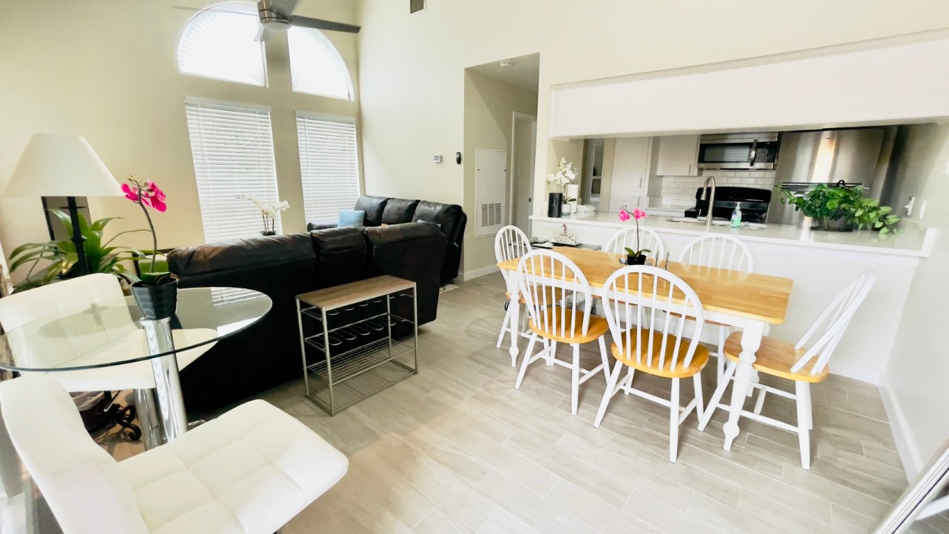 2902 Cole Street, Unit 311 Austin, TX 78705 - Photo 3 of 16 Dining space featuring ceiling fan, a high ceiling, and light wood-style flooring