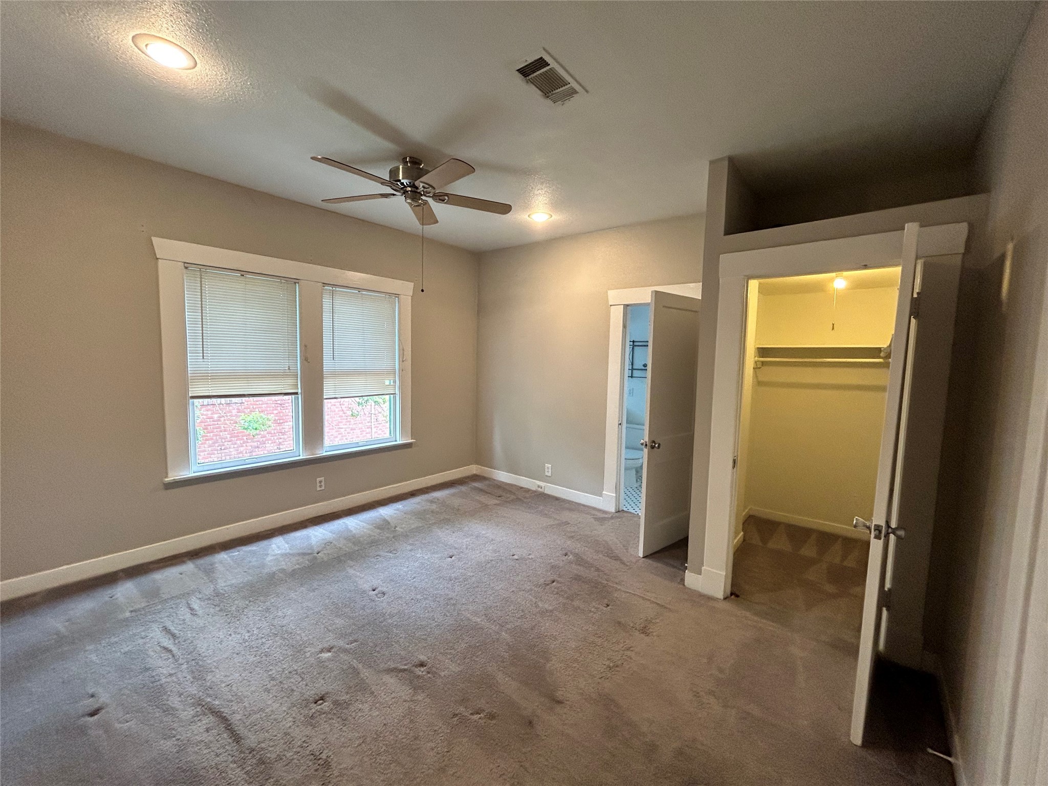 1639 Norfolk Street, Unit 2 Houston, TX 77006 - Photo 12 of 17 an empty room with windows and refrigerator