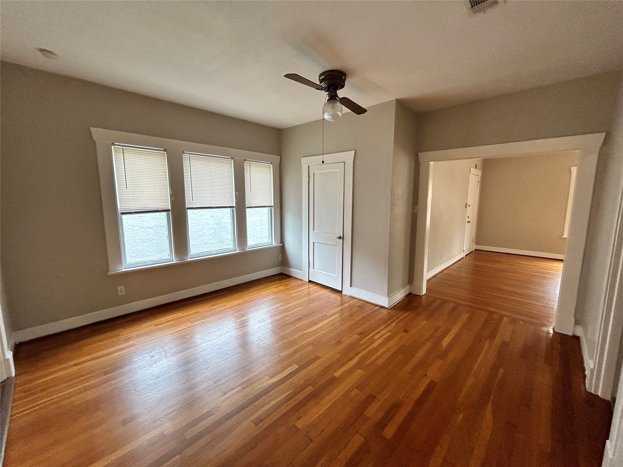 1639 Norfolk Street, Unit 2 Houston, TX 77006 - Photo 4 of 17 a view of an empty room with wooden floor and a window