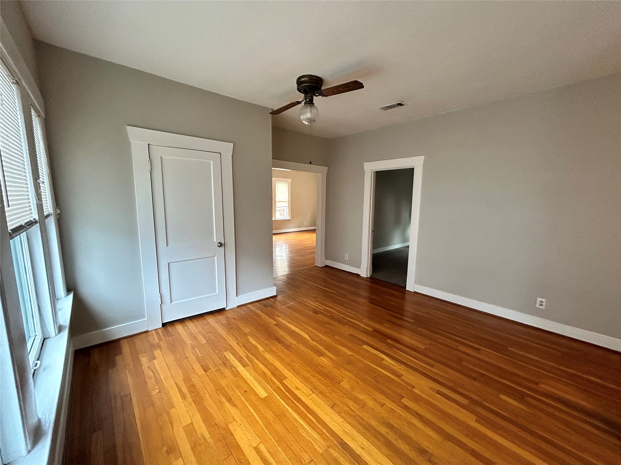 1639 Norfolk Street, Unit 2 Houston, TX 77006 - Photo 5 of 17 a view of an empty room with wooden floor and a window