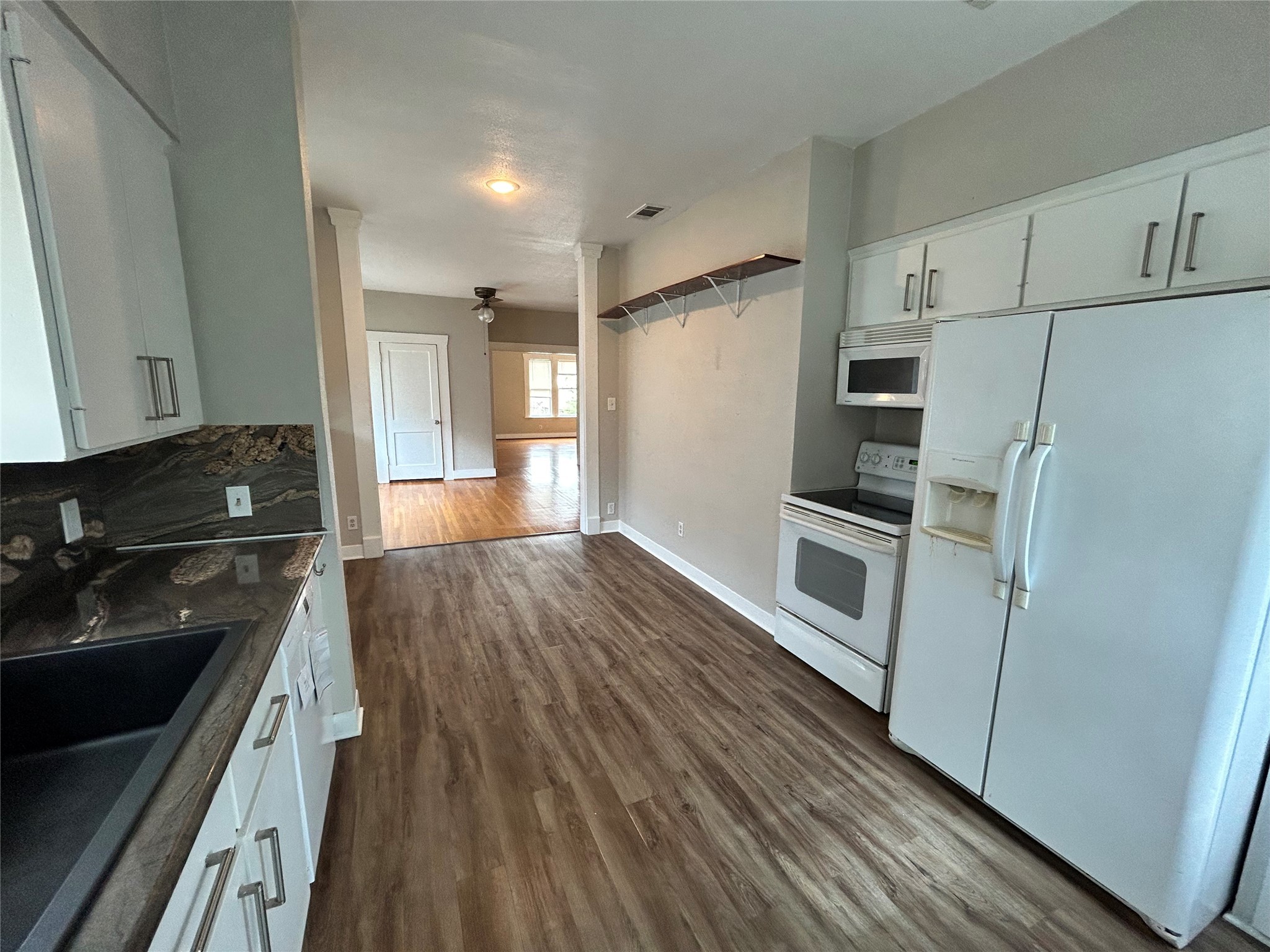 1639 Norfolk Street, Unit 2 Houston, TX 77006 - Photo 9 of 17 a kitchen with a refrigerator and a stove top oven