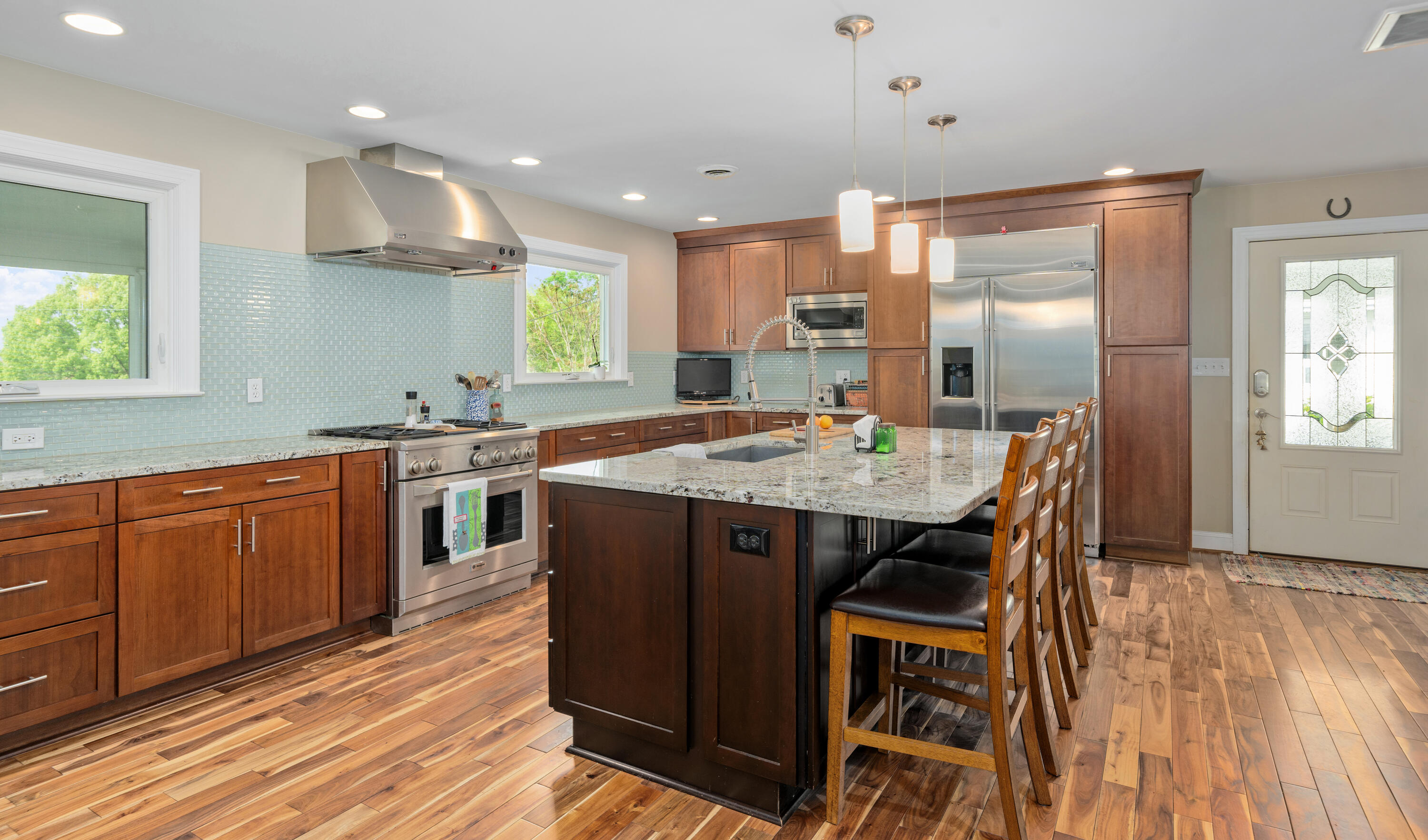 1719 Blair Road Southwest Roanoke, VA 24015 - Photo 12 of 40 a kitchen with stainless steel appliances kitchen island granite countertop a table chairs and a sink