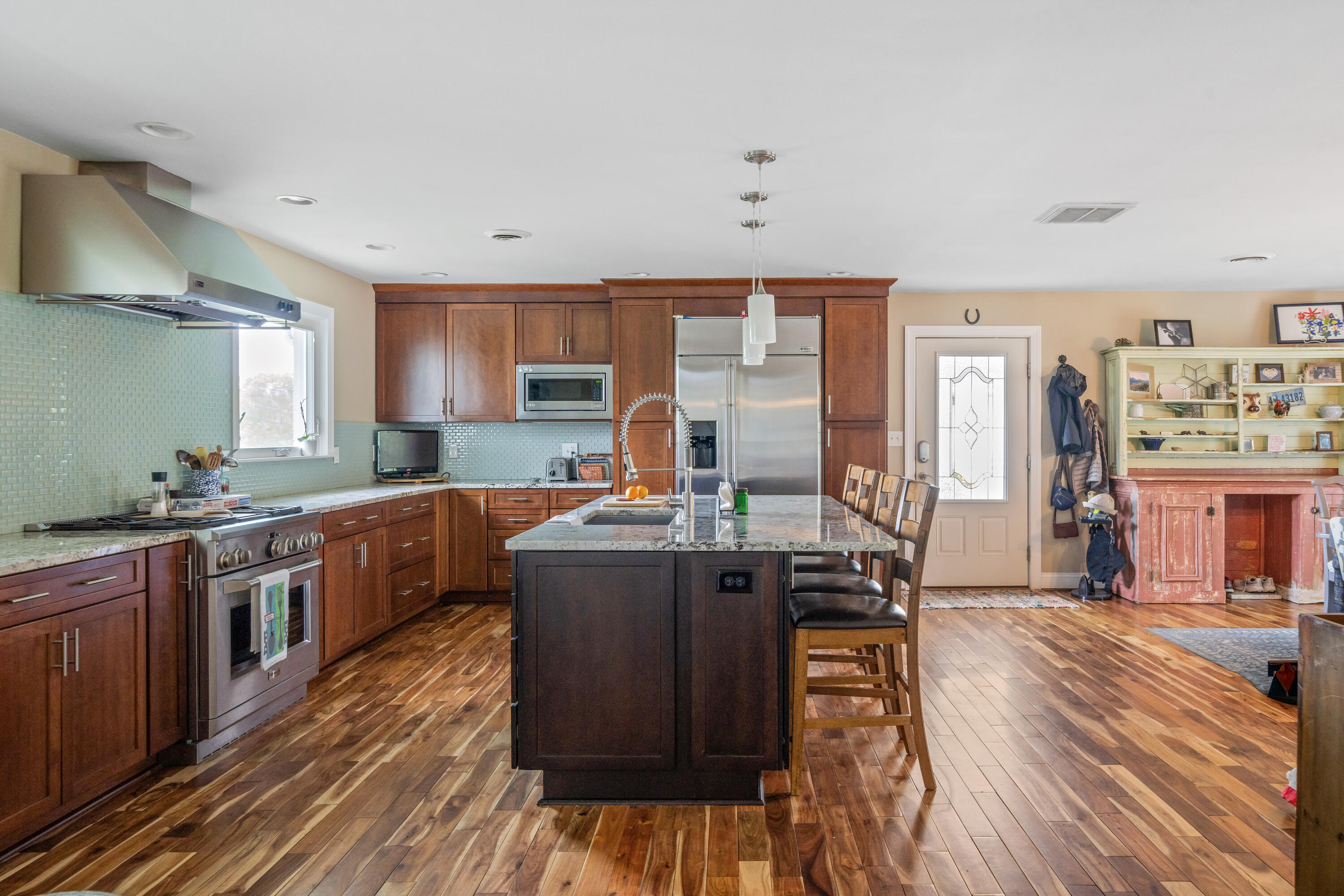 1719 Blair Road Southwest Roanoke, VA 24015 - Photo 10 of 40 a open kitchen with stainless steel appliances granite countertop a stove top oven a sink dishwasher and cabinets with wooden floor