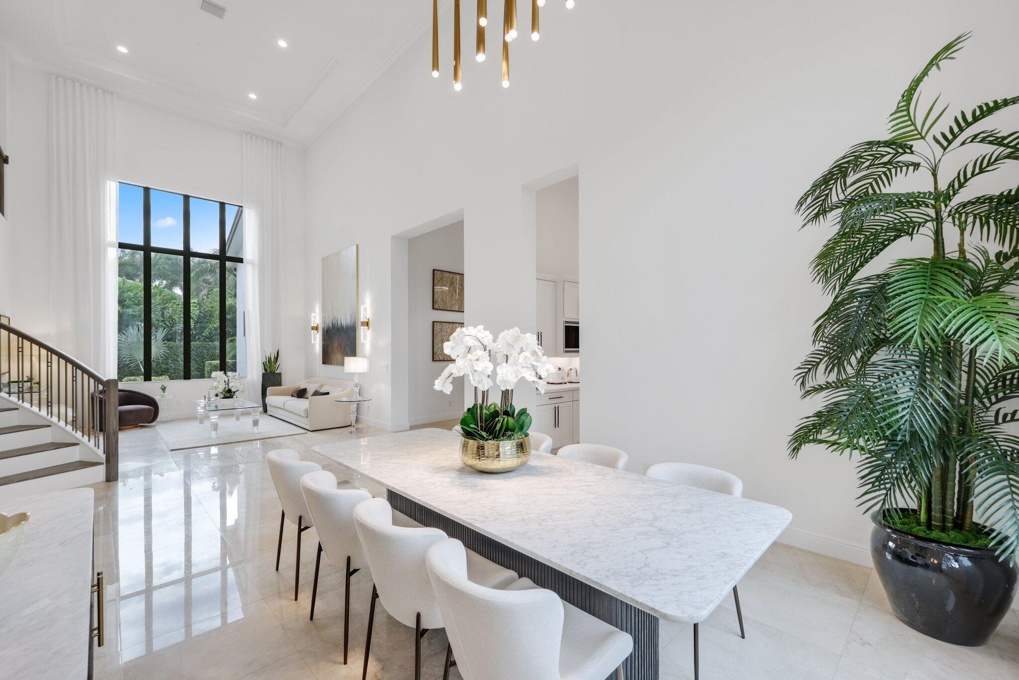 2751 Northwest 70th Boulevard Boca Raton, FL 33496 - Photo 11 of 76 a dining room with furniture and potted plants