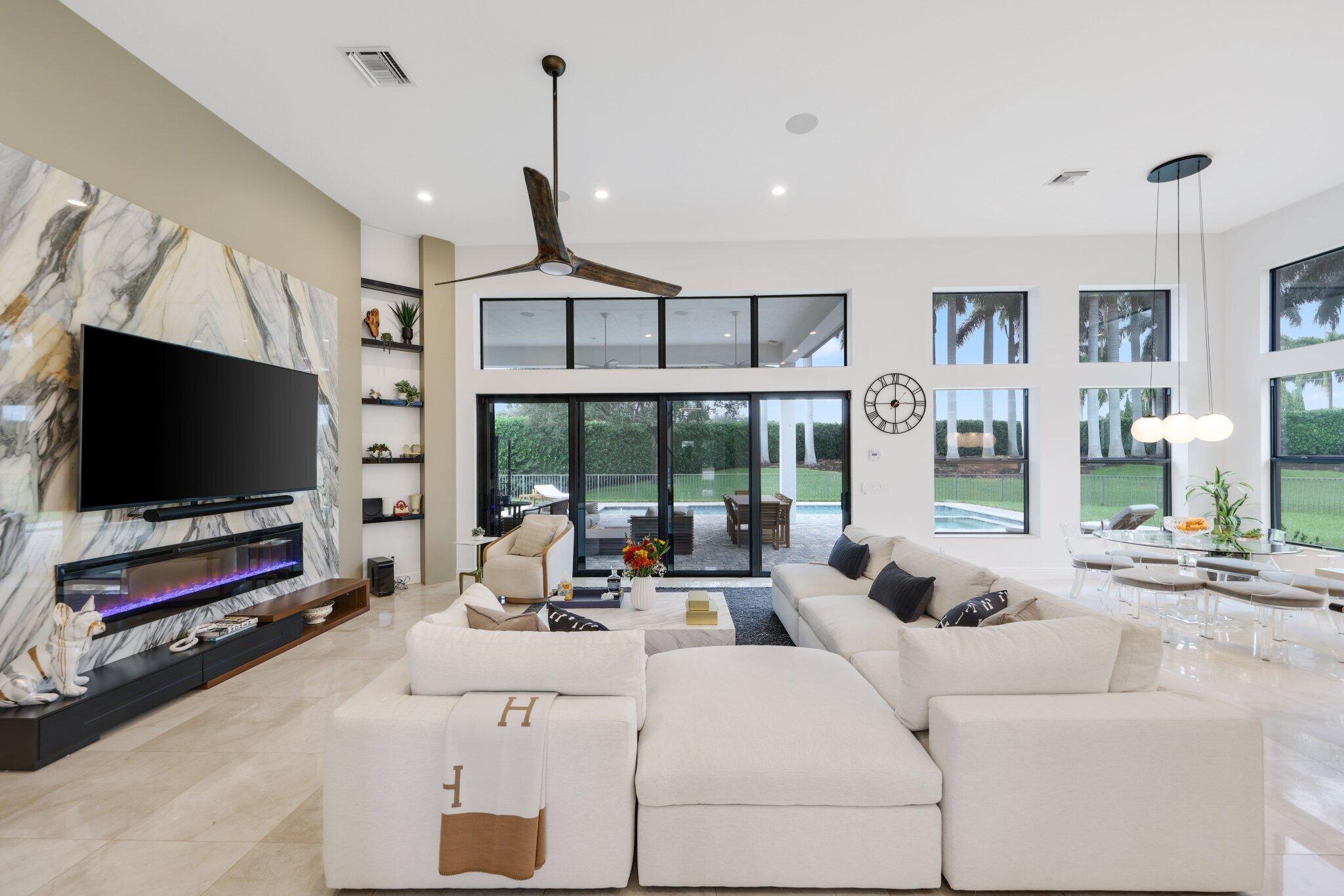 2751 Northwest 70th Boulevard Boca Raton, FL 33496 - Photo 16 of 76 a living room with furniture and a flat screen tv