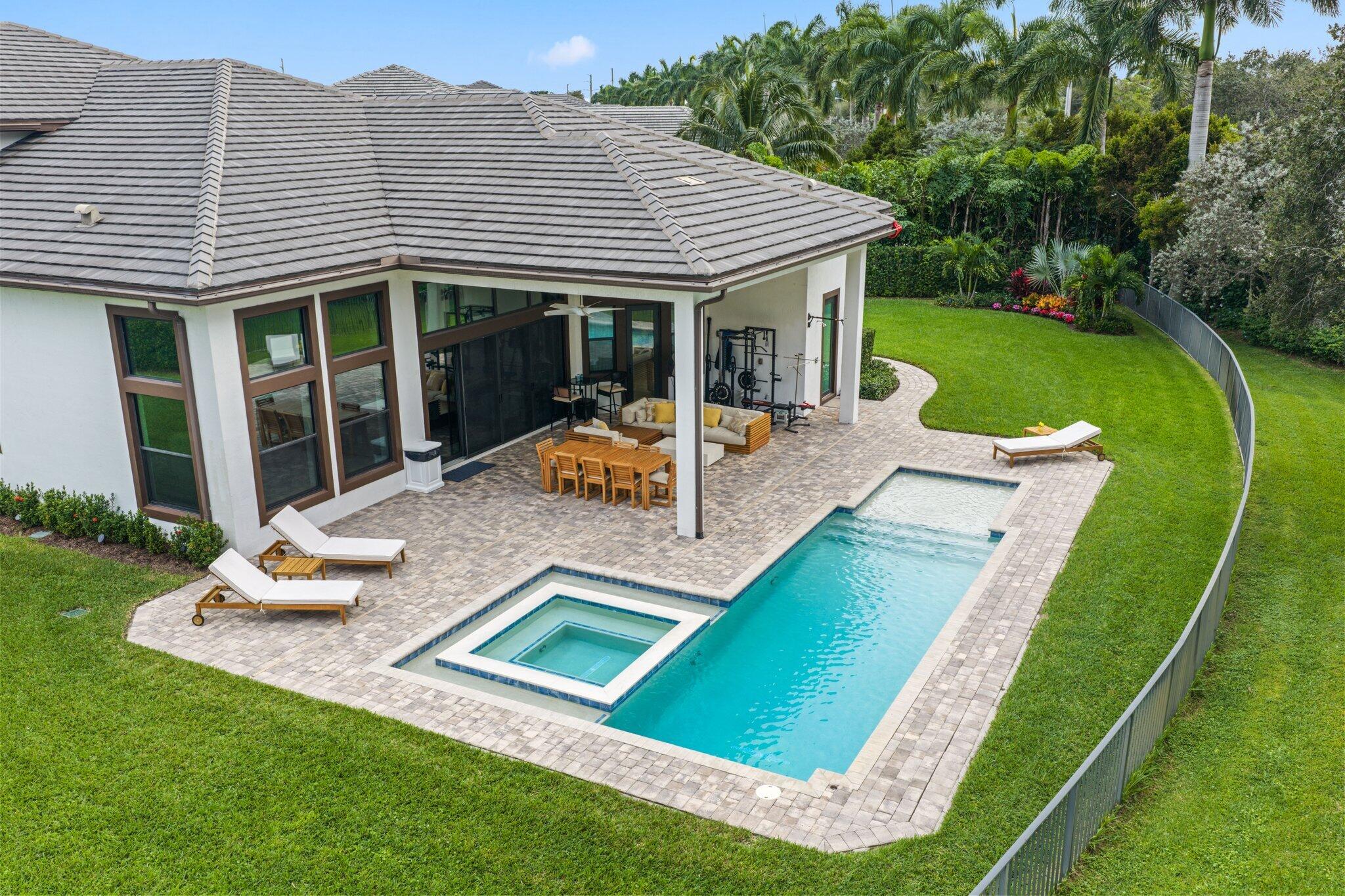 2751 Northwest 70th Boulevard Boca Raton, FL 33496 - Photo 2 of 76 a view of a house with backyard porch and sitting area