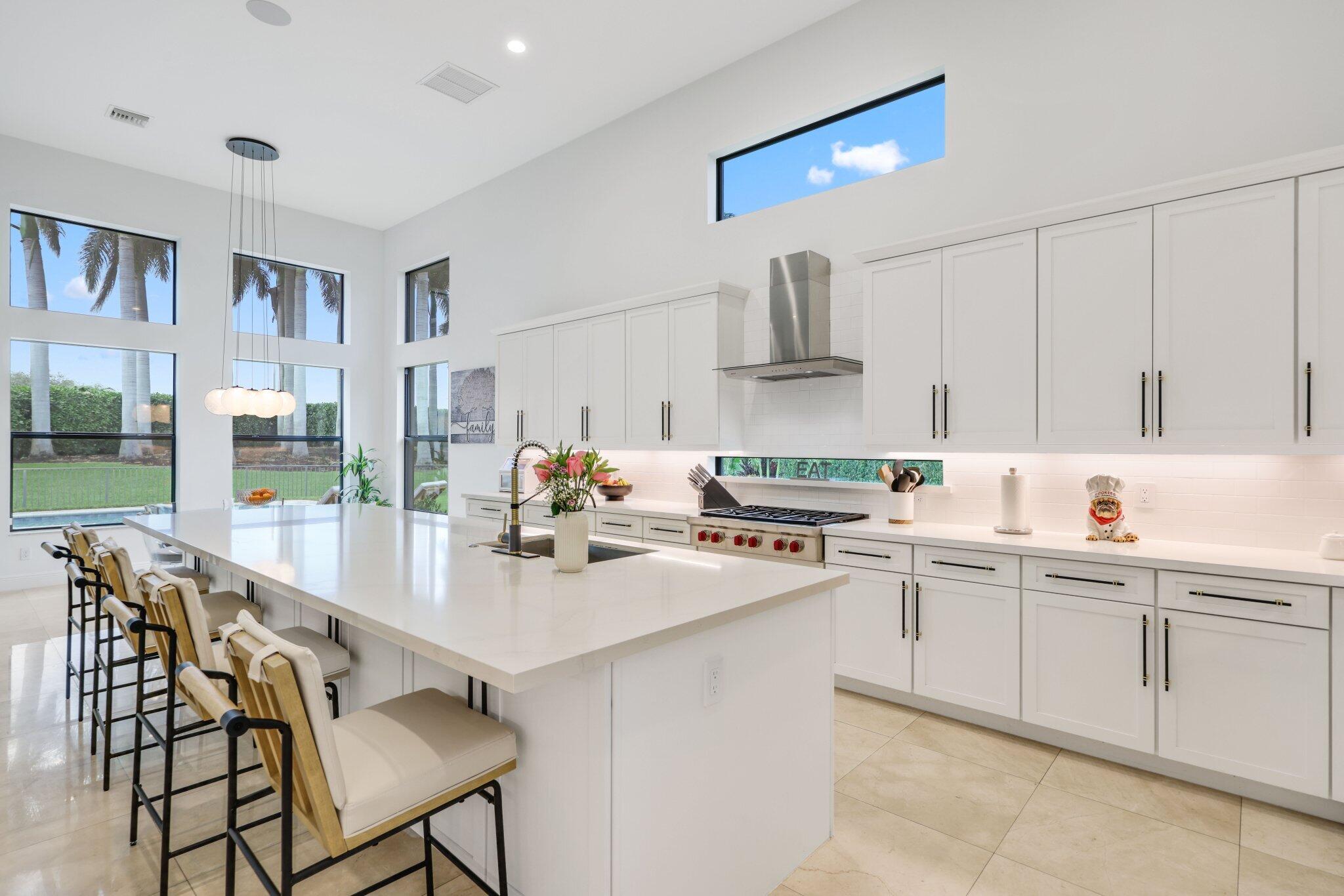 2751 Northwest 70th Boulevard Boca Raton, FL 33496 - Photo 23 of 76 a kitchen with appliances a sink and cabinets