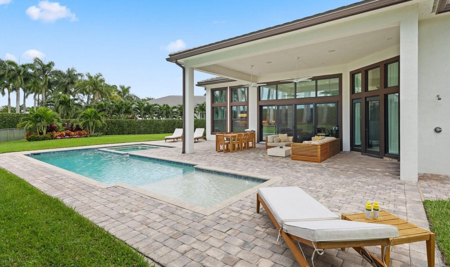 2751 Northwest 70th Boulevard Boca Raton, FL 33496 - Photo 33 of 76 a view of a backyard with swimming pool and furniture