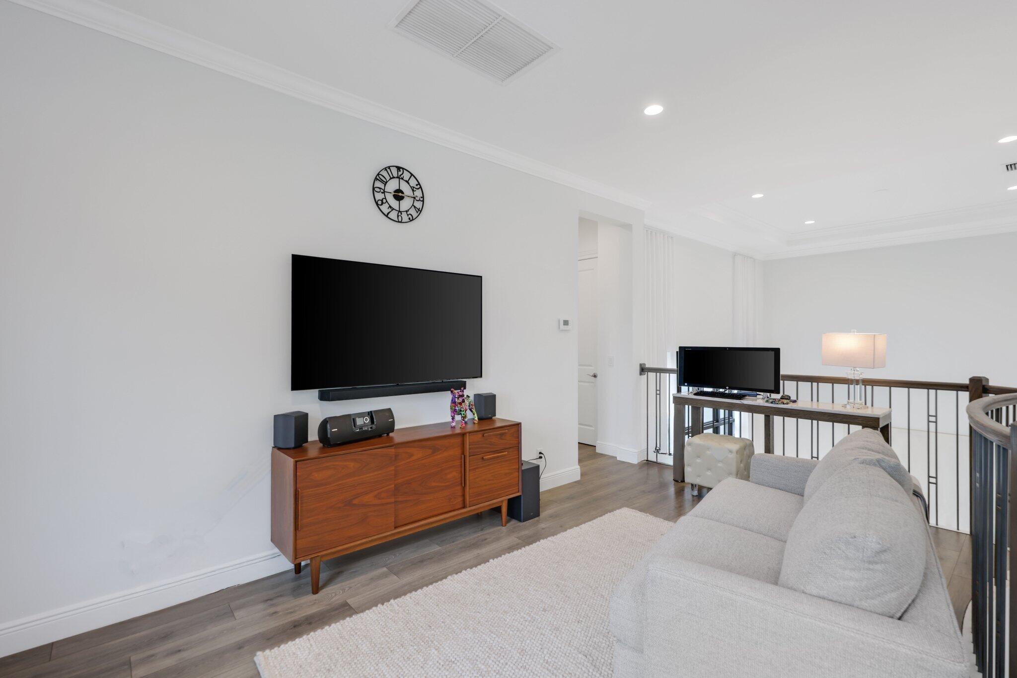 2751 Northwest 70th Boulevard Boca Raton, FL 33496 - Photo 44 of 76 a living room with furniture and a flat screen tv
