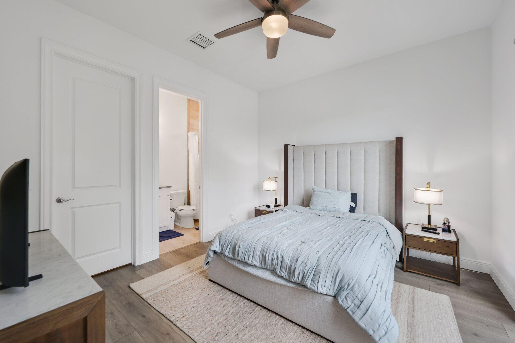 2751 Northwest 70th Boulevard Boca Raton, FL 33496 - Photo 45 of 76 a bedroom with a bed and a flat screen tv