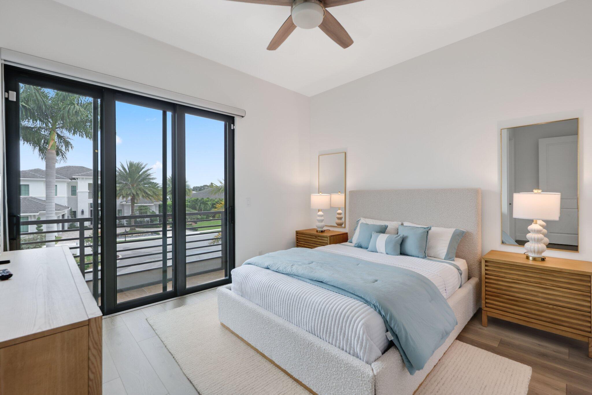 2751 Northwest 70th Boulevard Boca Raton, FL 33496 - Photo 47 of 76 a bedroom with a large bed and a large window