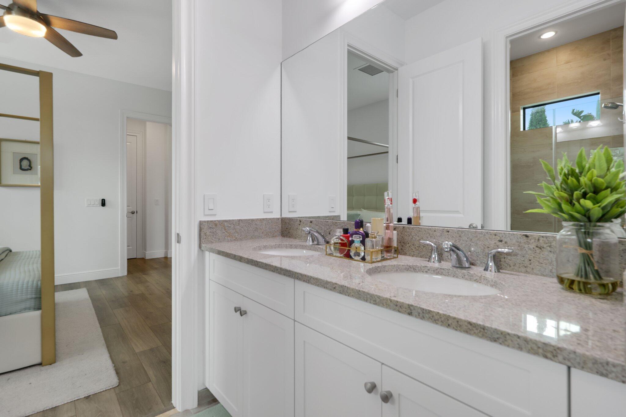 2751 Northwest 70th Boulevard Boca Raton, FL 33496 - Photo 49 of 76 a bathroom with double sink and a mirror