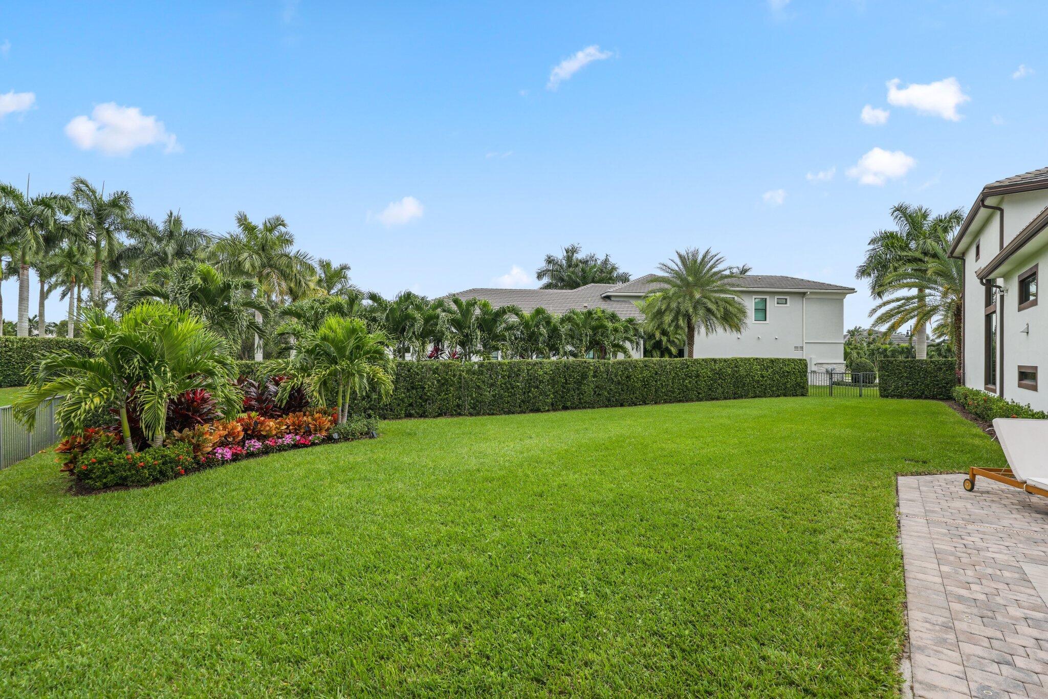 2751 Northwest 70th Boulevard Boca Raton, FL 33496 - Photo 60 of 76 a view of a garden with a building in the background