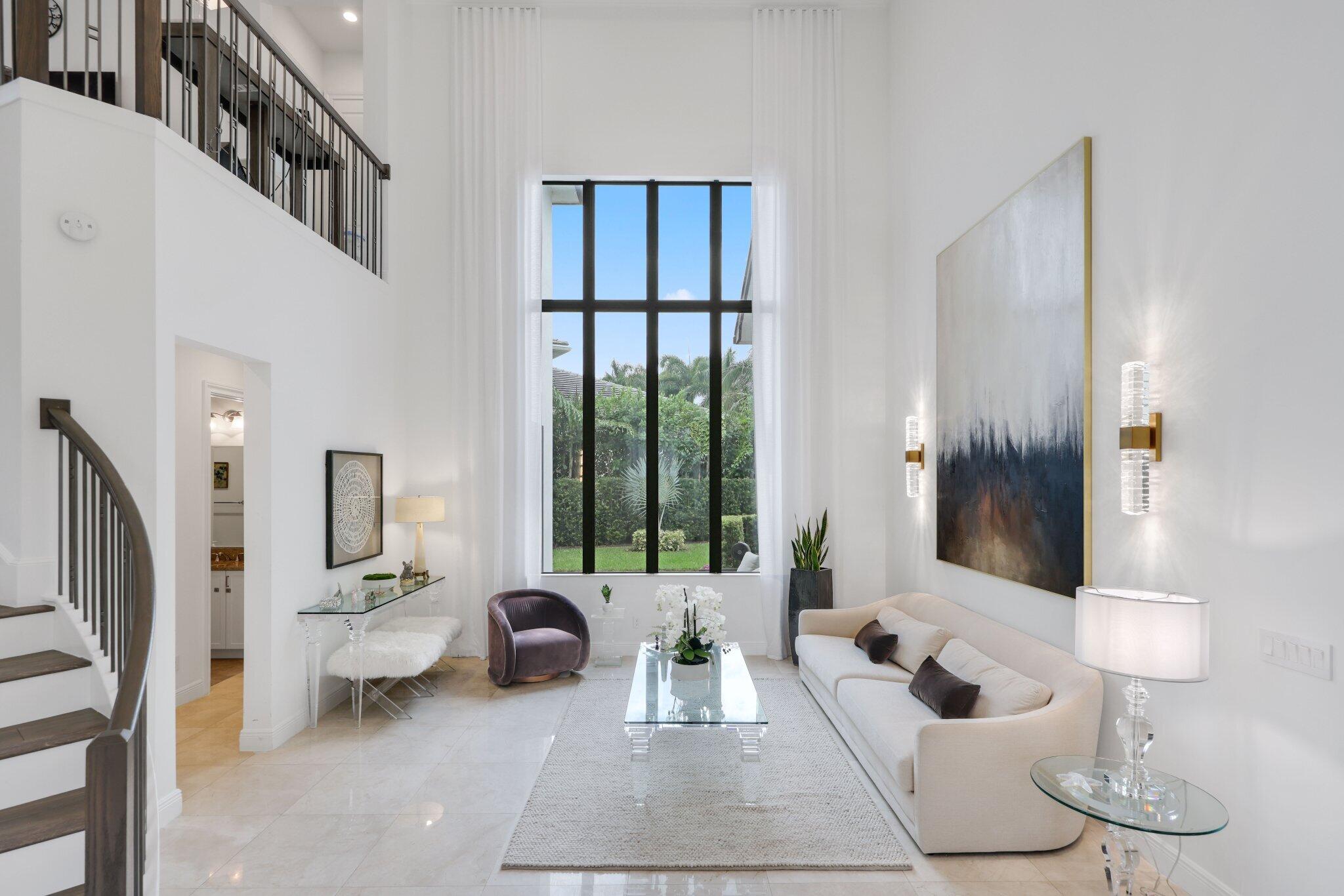 2751 Northwest 70th Boulevard Boca Raton, FL 33496 - Photo 8 of 76 a living room with furniture and a large window