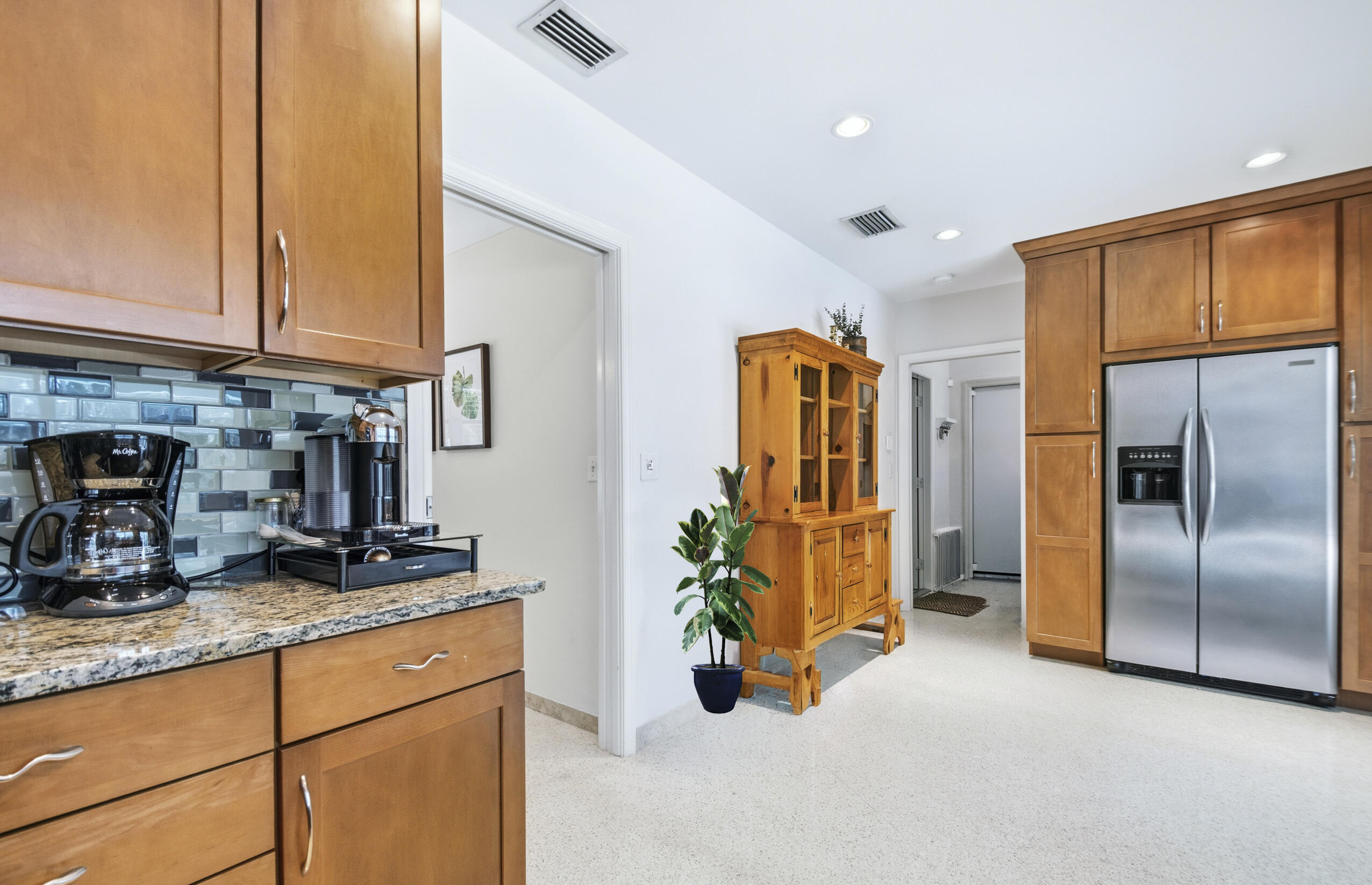 1348 Southwest 4th Street Boca Raton, FL 33486 - Photo 12 of 44 a kitchen with stainless steel appliances granite countertop a refrigerator and a sink