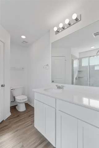 a bathroom with a glass shower door