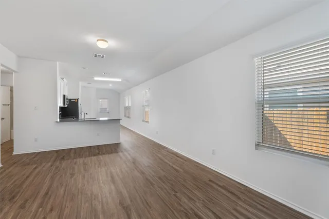 an empty room with wooden floor