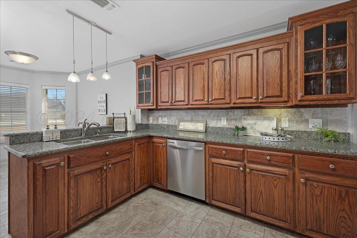 8501 Bryeson Lane Canyon, TX 79015 - Photo 11 of 25 a kitchen with stainless steel appliances granite countertop a sink and cabinets