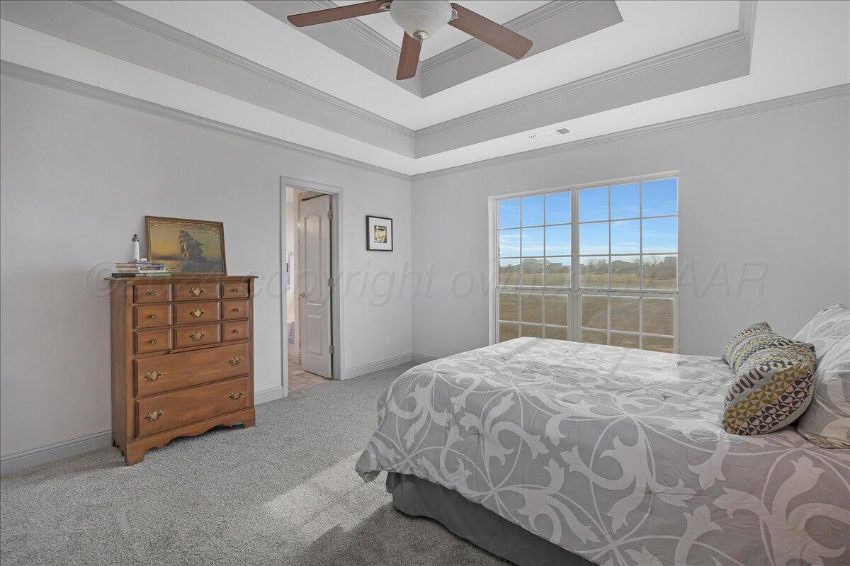 8501 Bryeson Lane Canyon, TX 79015 - Photo 15 of 25 a bedroom with a bed and a dresser