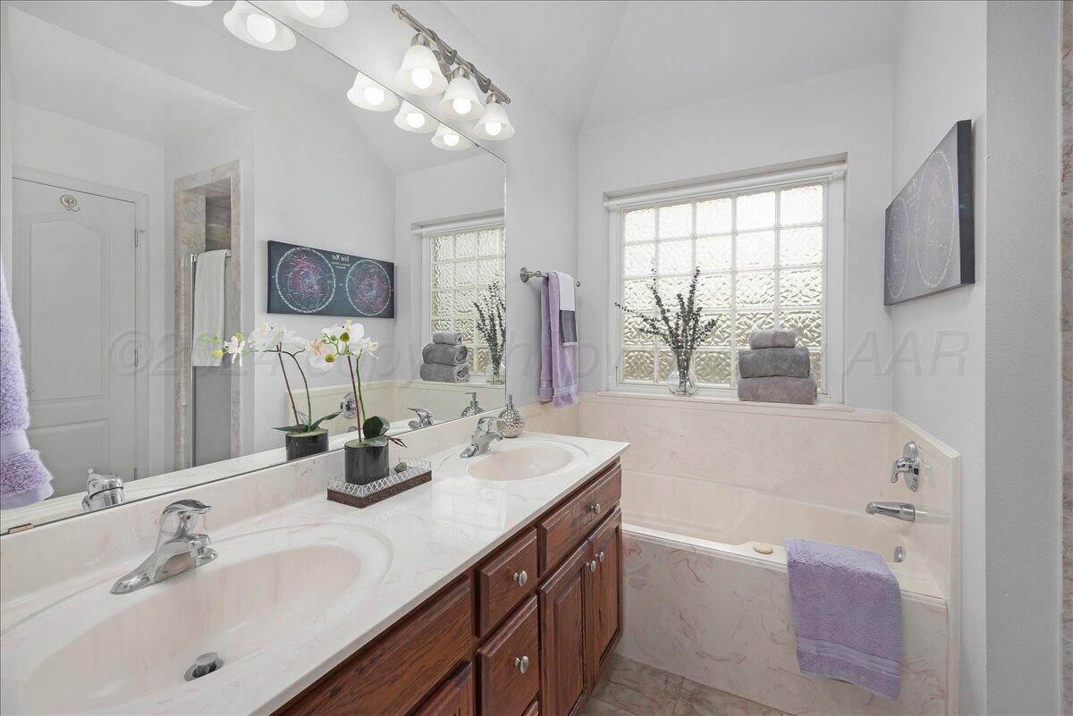 8501 Bryeson Lane Canyon, TX 79015 - Photo 16 of 25 a bathroom with a tub sink and mirror