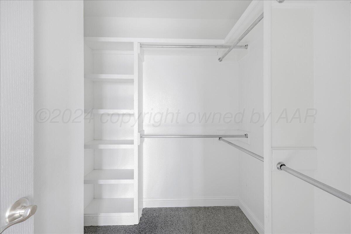 8501 Bryeson Lane Canyon, TX 79015 - Photo 17 of 25 a view of walk in closet with empty racks