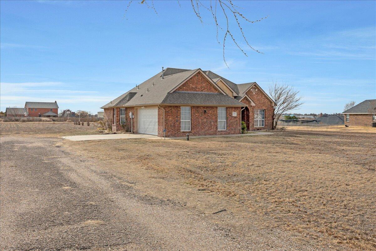 8501 Bryeson Lane Canyon, TX 79015 - Photo 2 of 25 a front view of a house with a garden