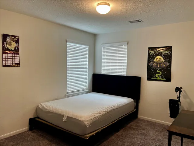 a bedroom with a bed and wall paintings