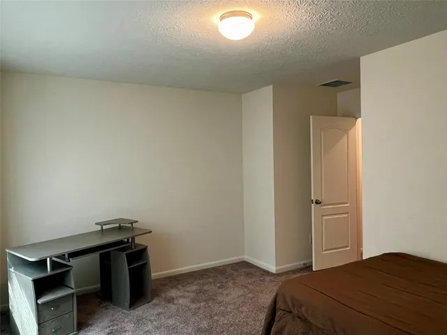 a bedroom with a bed and cabinets