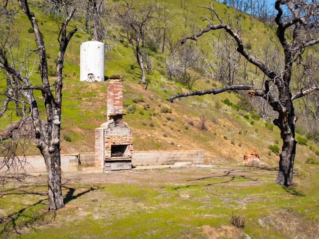 a small pool with some trees in the background