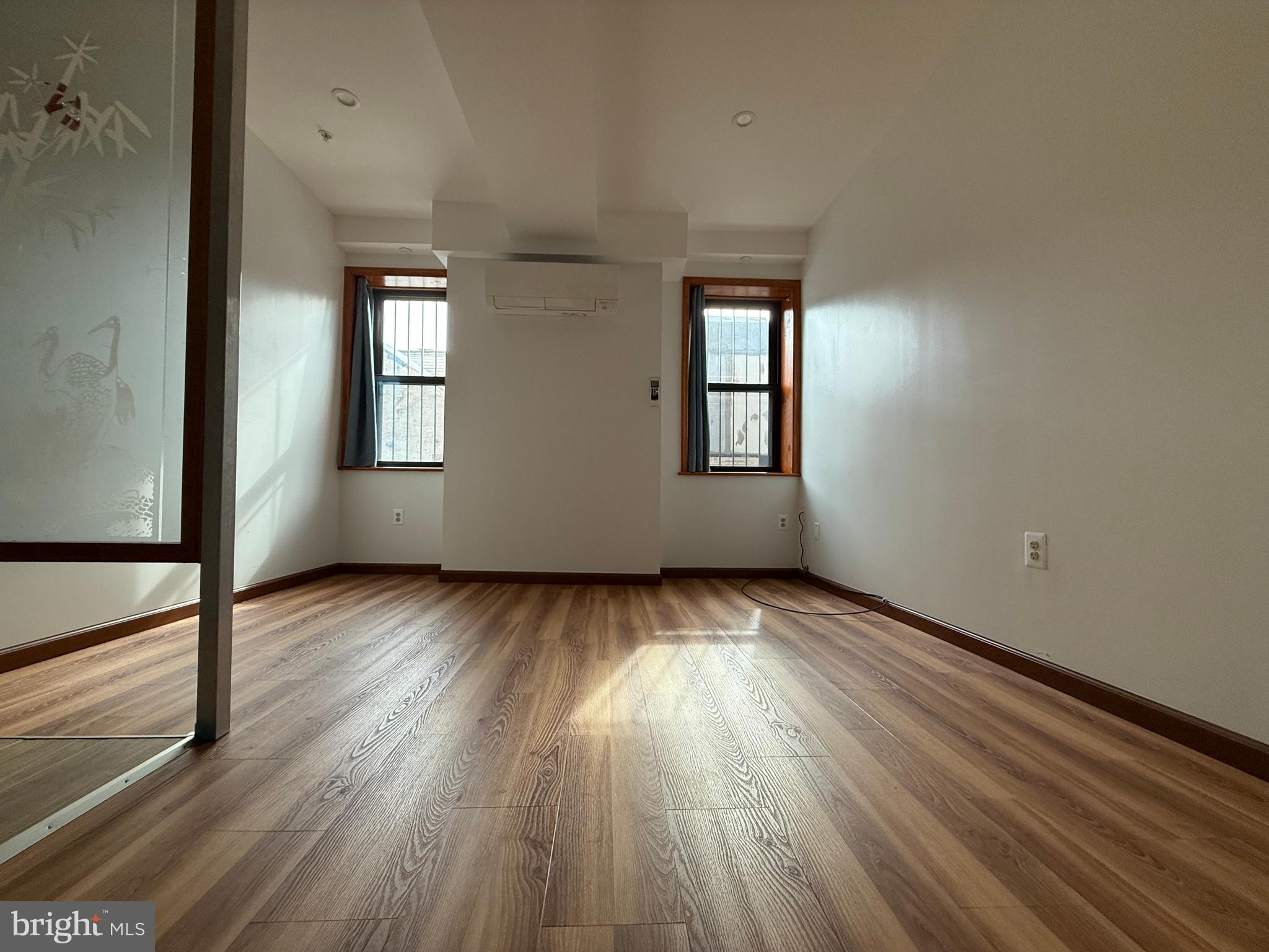 wooden floor in an empty room with a window