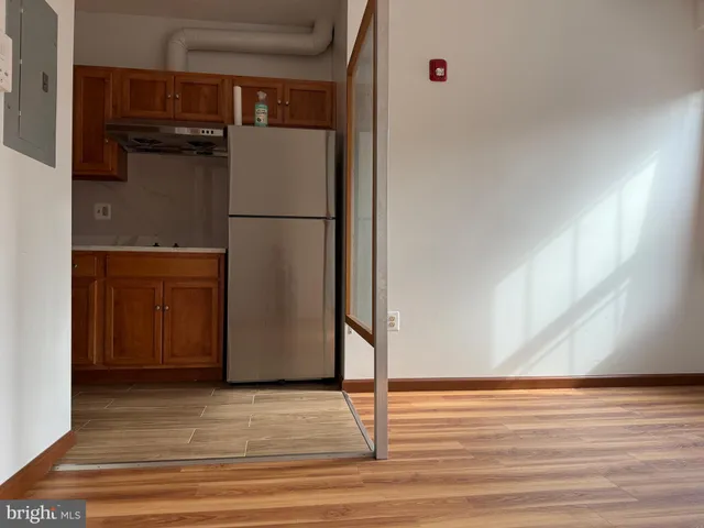 a refrigerator freezer sitting inside of a kitchen