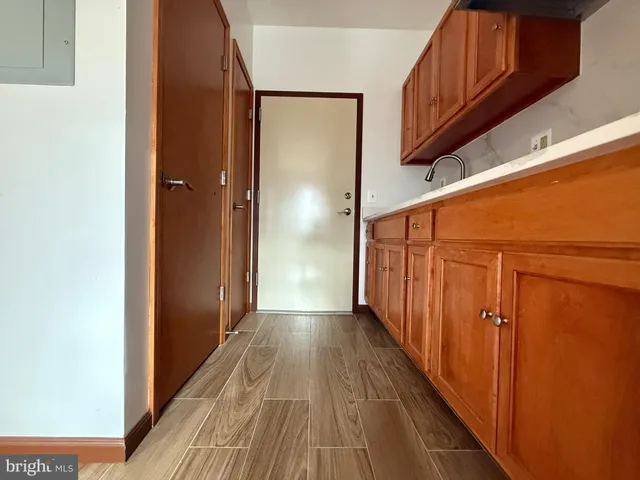a view of a hallway with wooden floor