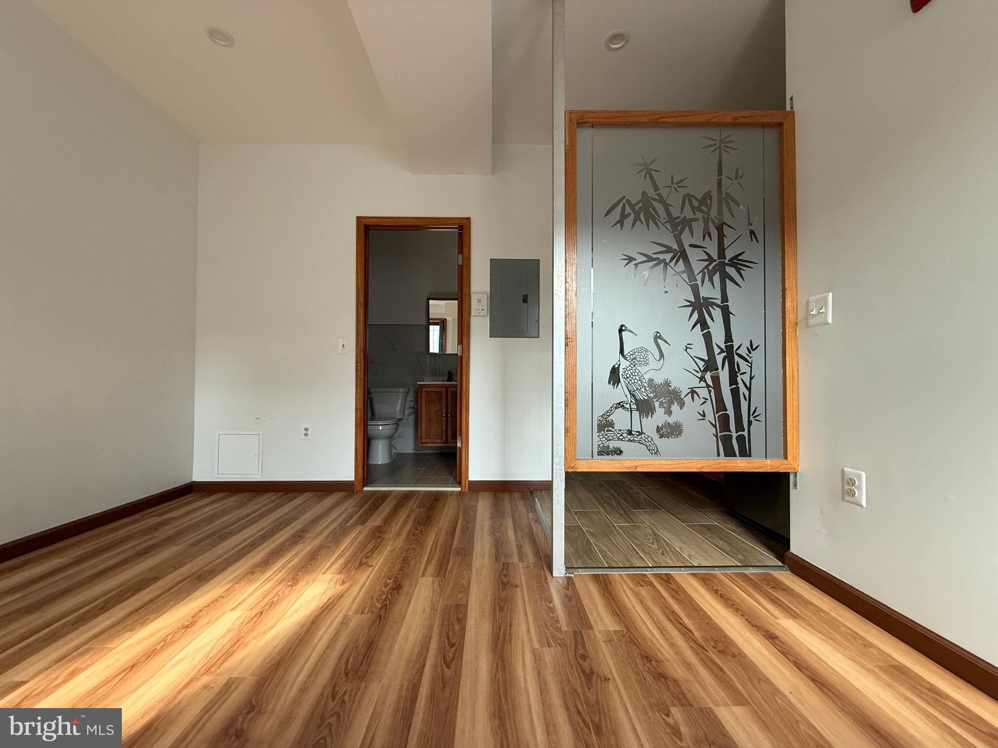 146 North 10th Street, Unit 3B Philadelphia, PA 19107 - Photo 8 of 8 a view of a room with wooden floor and a window