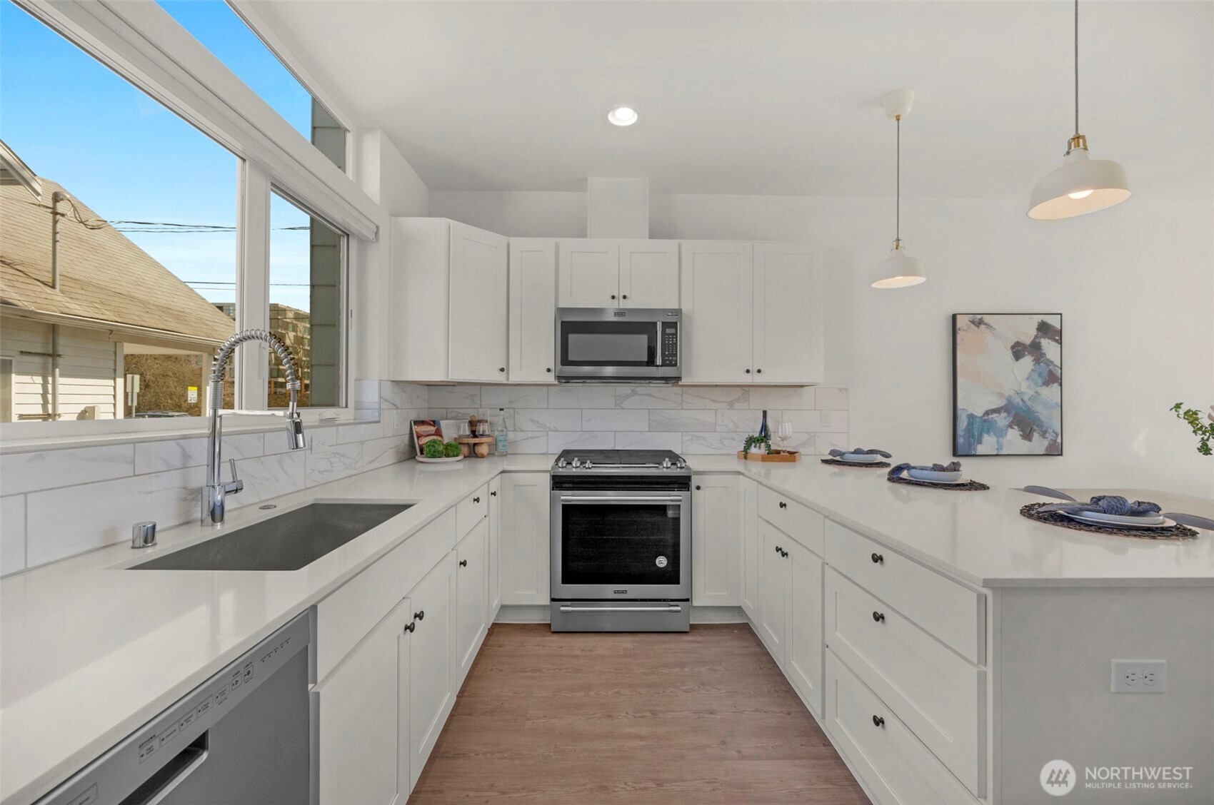 1966 South Grand Street Seattle, WA 98144 - Photo 10 of 25 a kitchen with stainless steel appliances granite countertop a sink a stove and a refrigerator