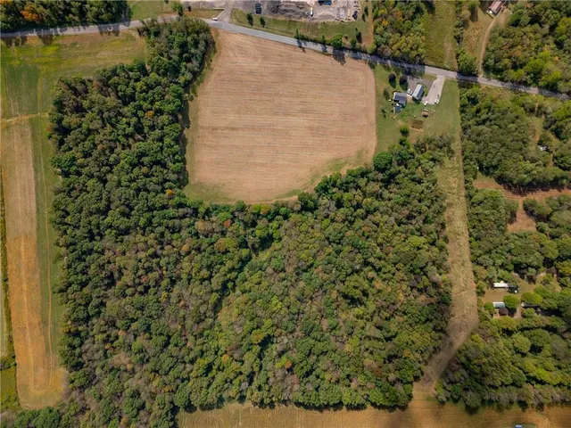 a view of a field with an trees in the background