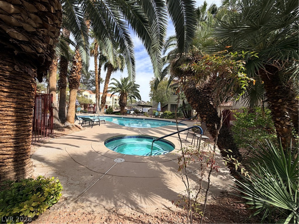 4955 South Lindell Road, Unit 203 Las Vegas, NV 89118 - Photo 25 of 31 This outdoor oasis features a refreshing pool and a relaxing spa, enveloped by lush palm trees.