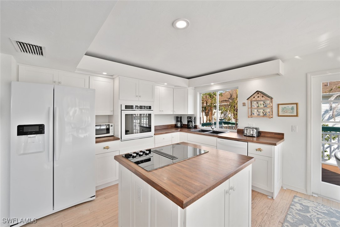 862 Beach Road Sanibel, FL 33957 - Photo 13 of 49 a kitchen with stainless steel appliances granite countertop a sink stove and refrigerator