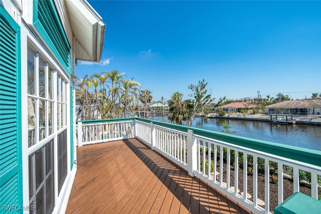 862 Beach Road Sanibel, FL 33957 - Photo 18 of 49 a view of a balcony with wooden floor and lake view