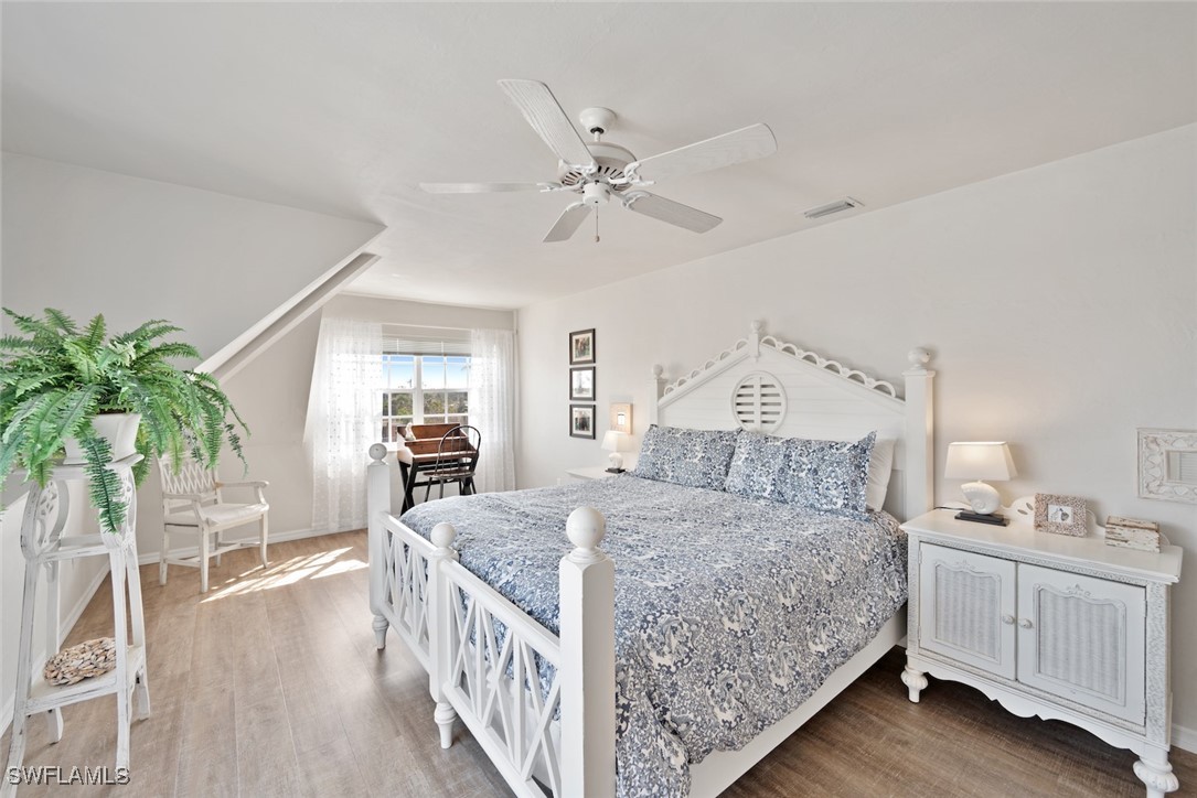 862 Beach Road Sanibel, FL 33957 - Photo 20 of 49 a bedroom with a bed and a chandelier