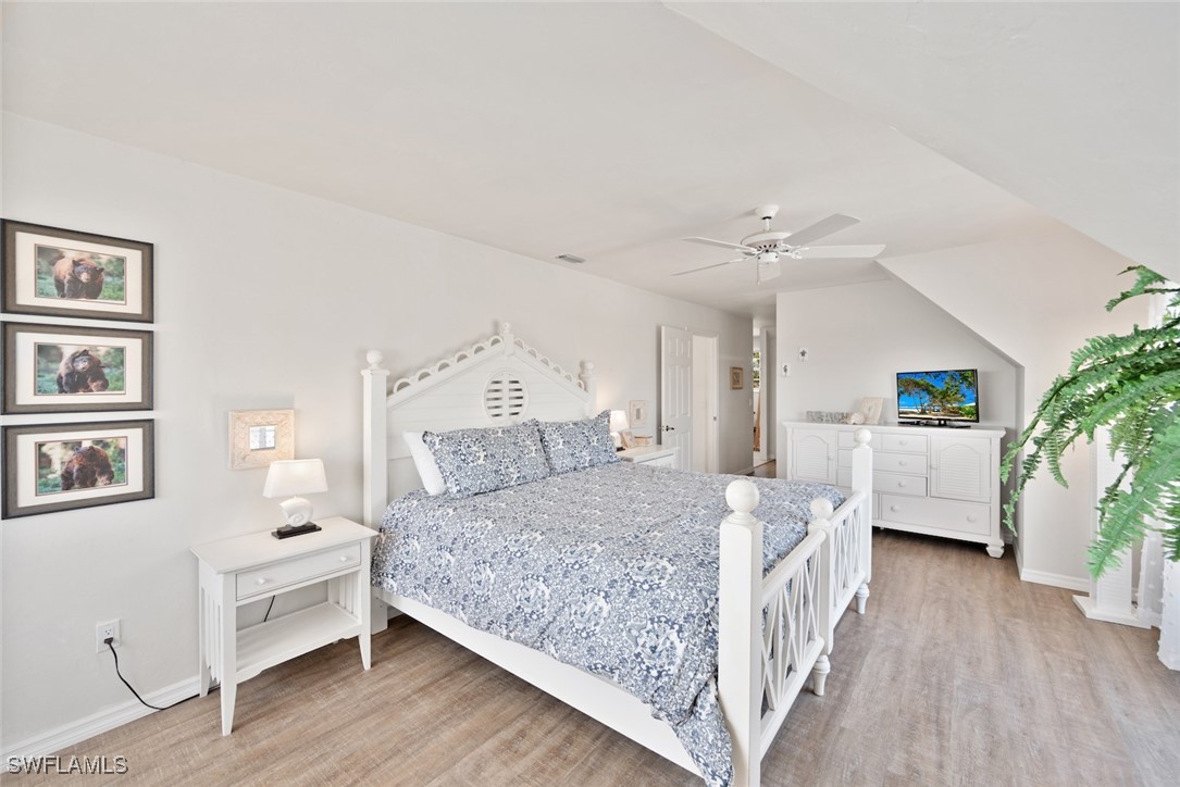 862 Beach Road Sanibel, FL 33957 - Photo 21 of 49 a bedroom with a bed and a couch