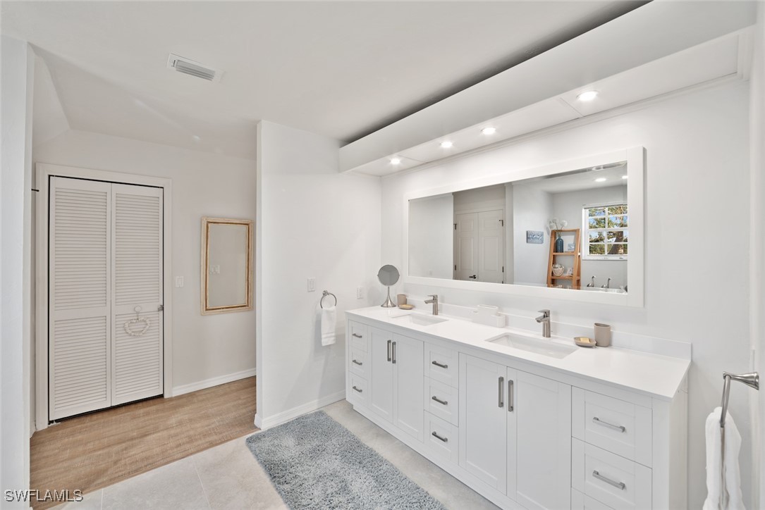862 Beach Road Sanibel, FL 33957 - Photo 22 of 49 a bathroom with a double vanity sink and mirror