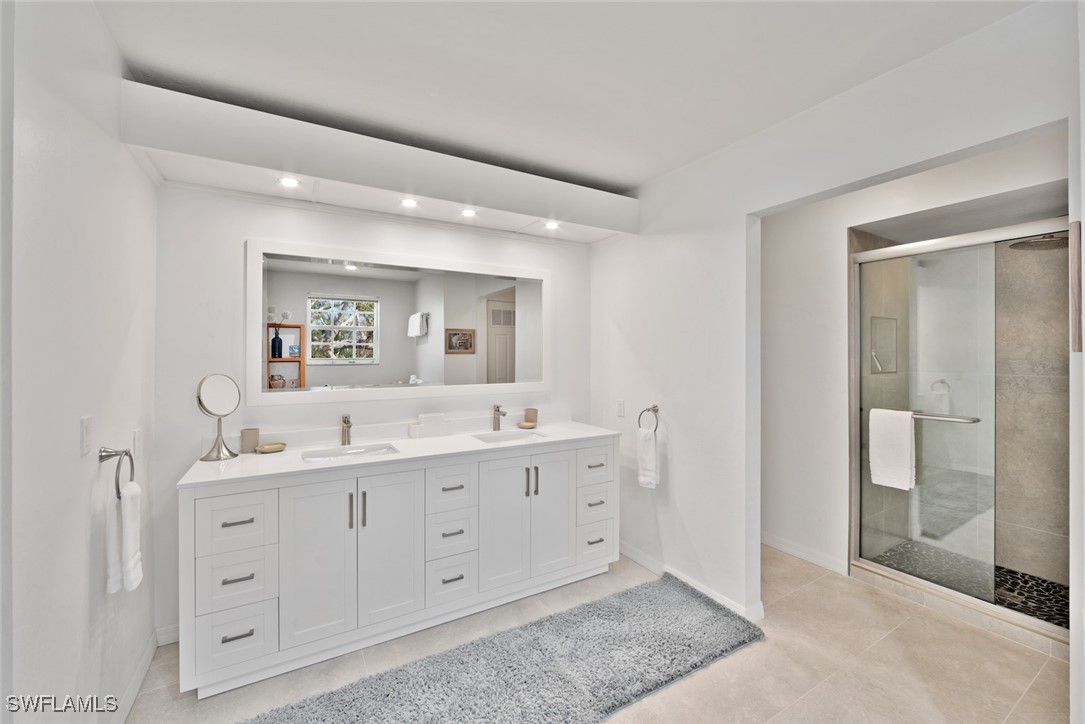 862 Beach Road Sanibel, FL 33957 - Photo 23 of 49 a bathroom with a double vanity sink and mirror