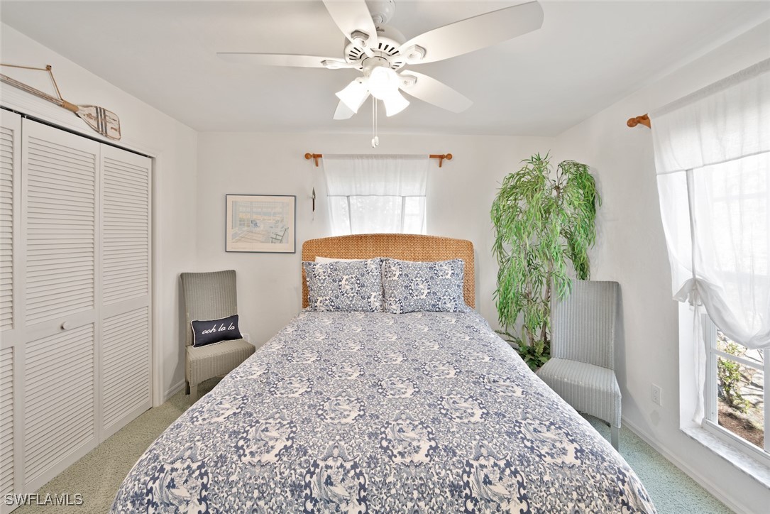 862 Beach Road Sanibel, FL 33957 - Photo 26 of 49 a bedroom with a bed and a chandelier