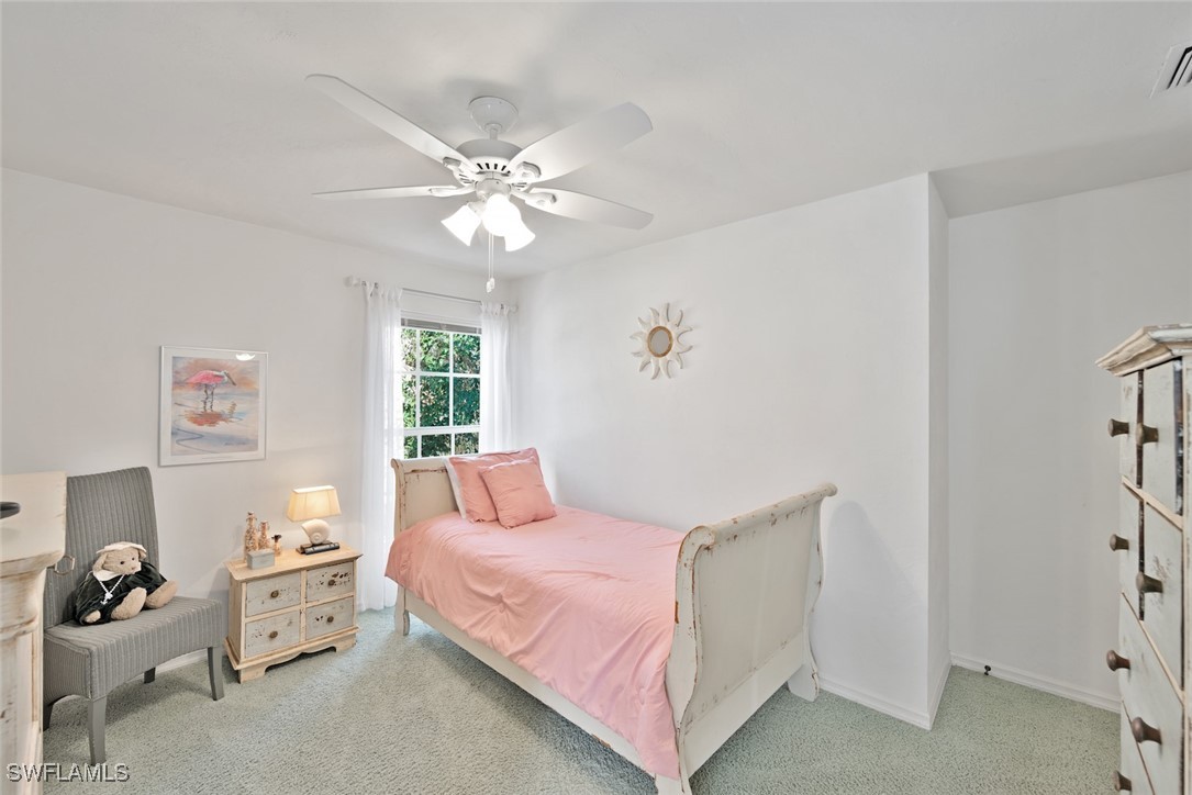 862 Beach Road Sanibel, FL 33957 - Photo 27 of 49 a bedroom with a bed and a window