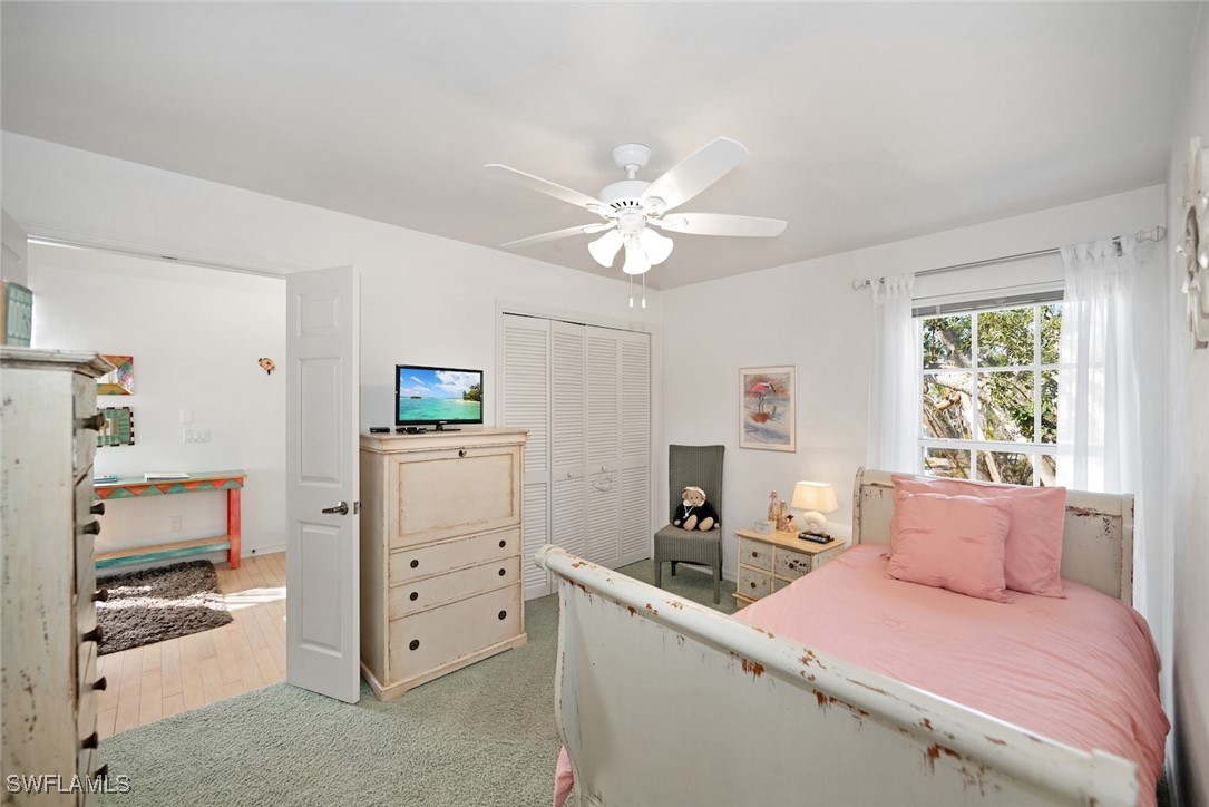 862 Beach Road Sanibel, FL 33957 - Photo 28 of 49 a bedroom with a bed and a chandelier
